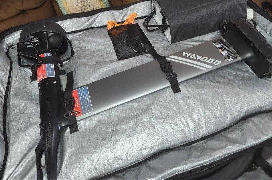 Surfboard in a bag with a desk and computer in the background