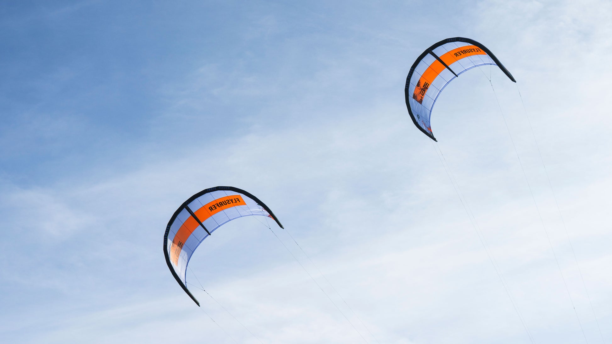 Two Indie freeride Progresson wave one strut kiteboarding kites in a pretty blue and orange colors.